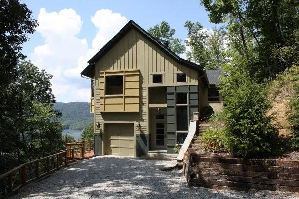 a tan mountain home with brighter tan and greenish grey accents