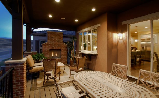 kitchen and fireplace seating area connected by white pass through window with white counter