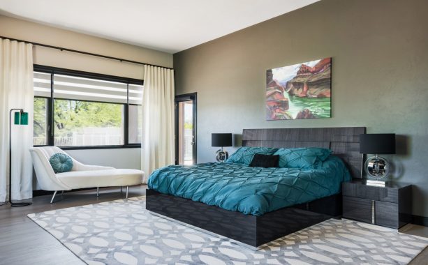 a black modern bed decorated with teal bedding set