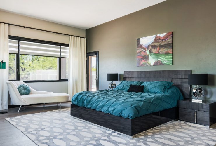 a black modern bed decorated with teal bedding set
