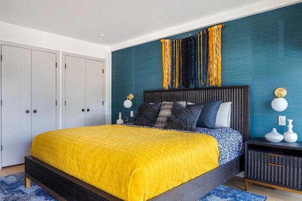 a contemporary black and teal bedroom with fun touches of yellow