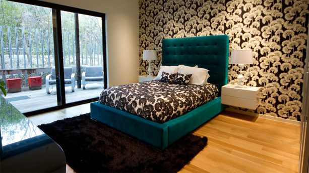 a modern teal bedroom paired with black area rug
