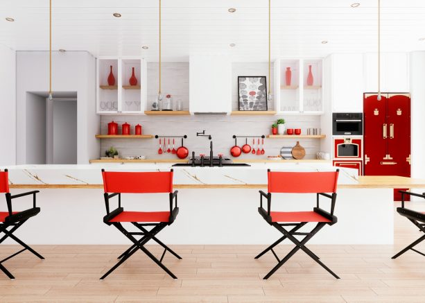 a white kitchen looks stunning with the addition of red and black dining chairs in director-style