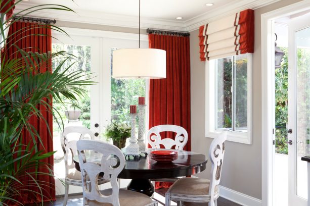 an elegant, luxurious kitchen nook with black, white, and red color theme