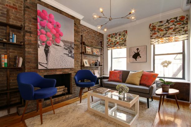 a brick fireplace with custom contemporary wall-mount bookshelves on the sides