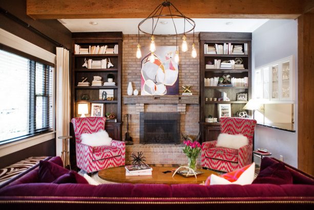 a rustic brick fireplace get a glamor enhancement because of the brown weathered wood custom bookshelves in both sides
