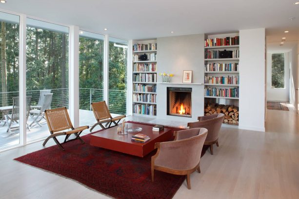 a simple and minimalist fireplace paired with unique built-in bookshelves that comes with stainless-steel box feature for storing wood.jpg