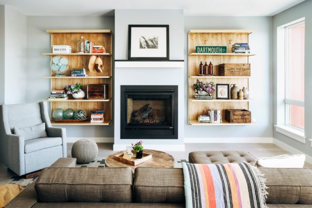 a simple, black, standard fireplace paired with a two medium-tone bookshelves in floating style