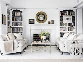 elegant and luxurious design of a classic, traditional white fireplace with custom white bookshelves surrounding it