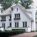 a traditional home exterior design with cinder block walls painted in white