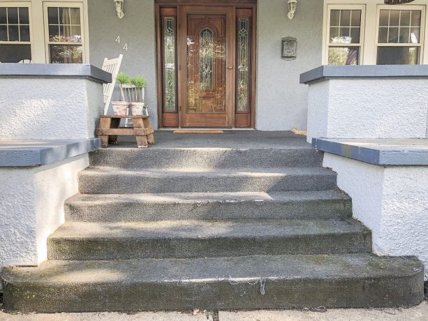 the carpeted concrete front steps looks outdated before the makeover