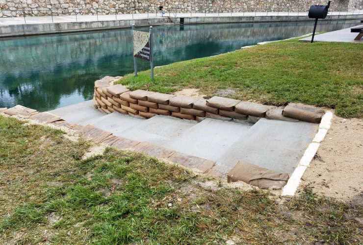 the combination of steps and concrete bags retaining walls in a riverside