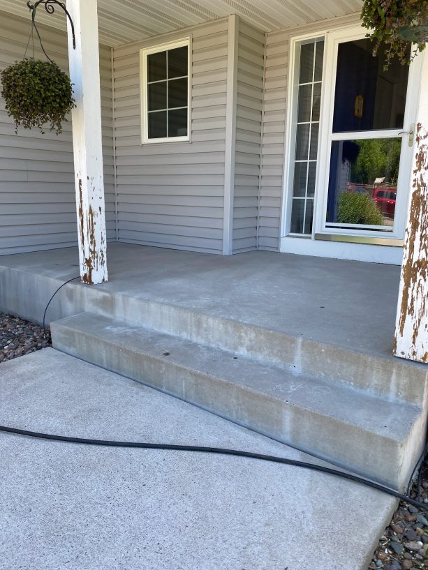 the concrete steps and porch after being prepared for the makeover