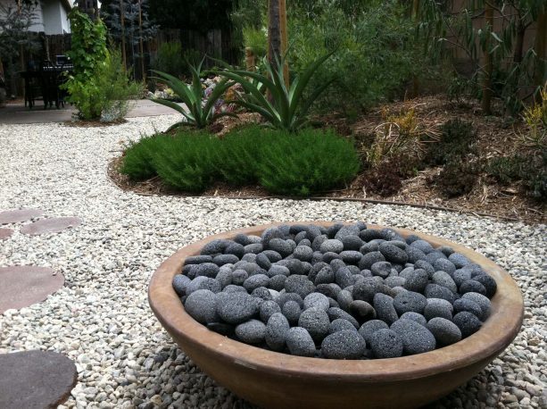 a neater look with round fire pit and round black lava rocks inside it