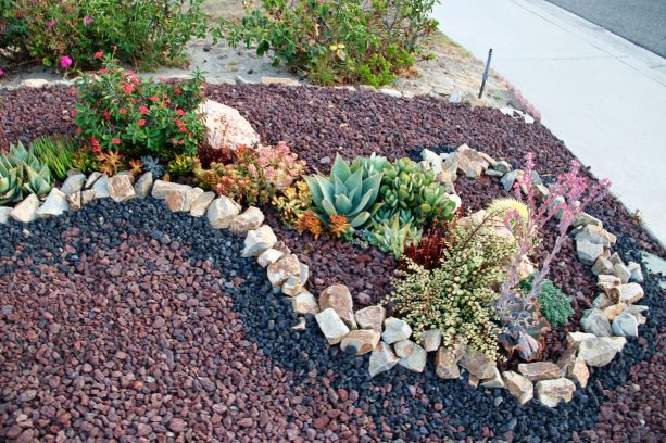 a swirl pattern in a landscape design with black lava and some other rock types