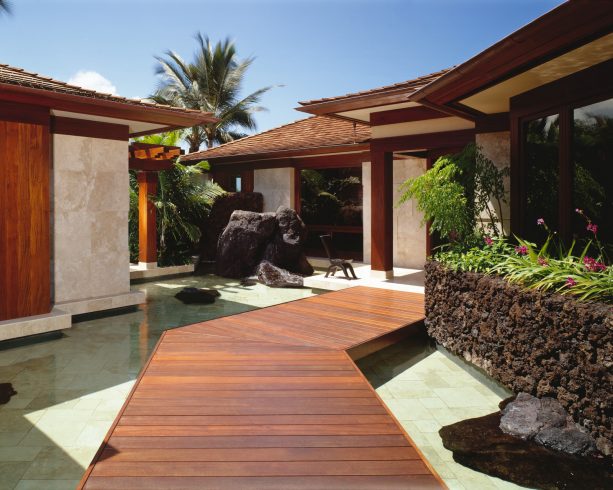 black lava rock wall with planter on the top