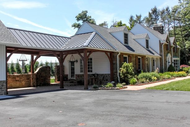 the covered garage walkways is connected to the house’s side entrance