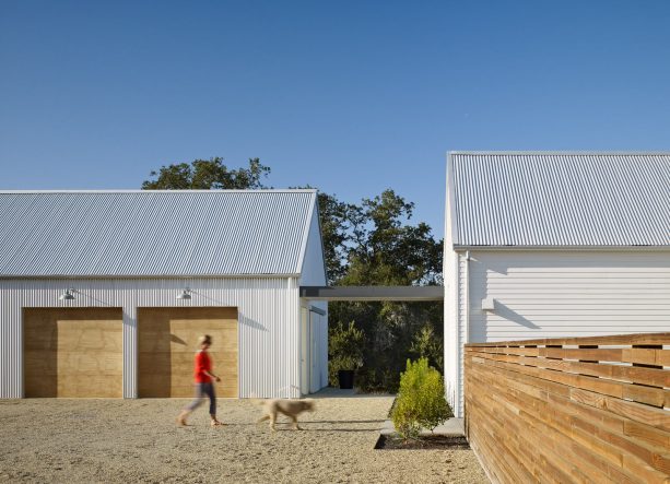 the house and the farmhouse garage is connected with a walkway covered with a roof-extension from the main building