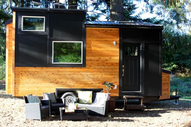 a modern tiny house with small deck on the roof