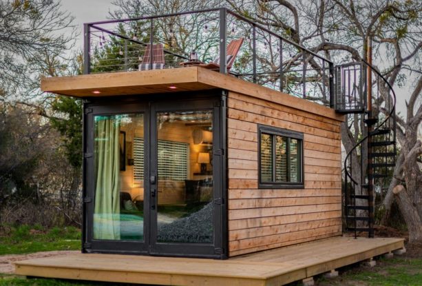 a super tiny house with roof deck with spiral staircase