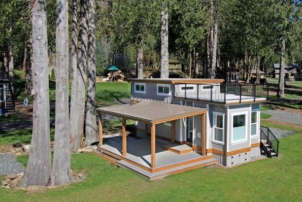 gorgeous grey and wood craftsman tiny house with roof deck and covered porch