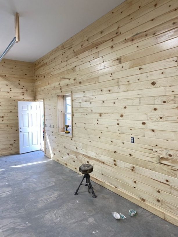 the interior walls are covered decoratively with finished, knotty wood siding