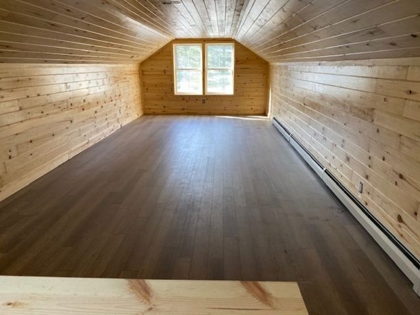 the loft interior looks so neat because of the wood siding