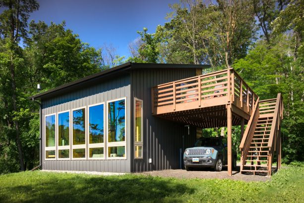 the roof deck is accessible through the wooden staircase