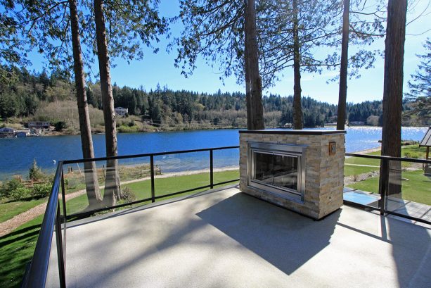 the roof deck with fireplace is perfect for enjoying the lake view