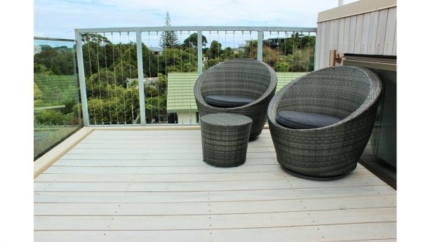 the small roof deck looks cozy with the choices of chairs and table set