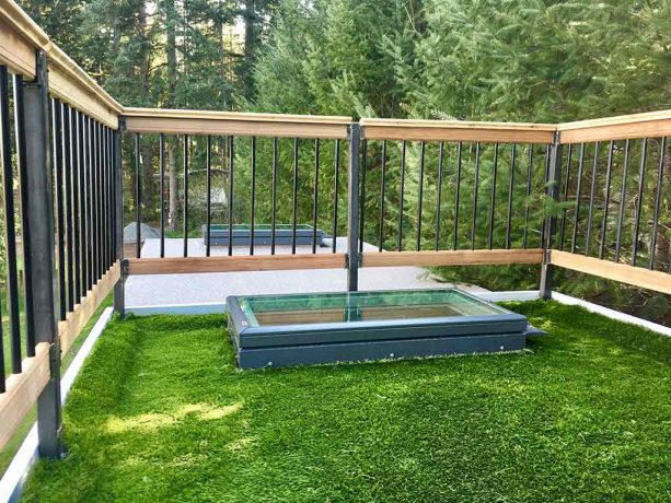 the unique roof deck has a grass flooring and a skylight that gives extra light to the bedroom