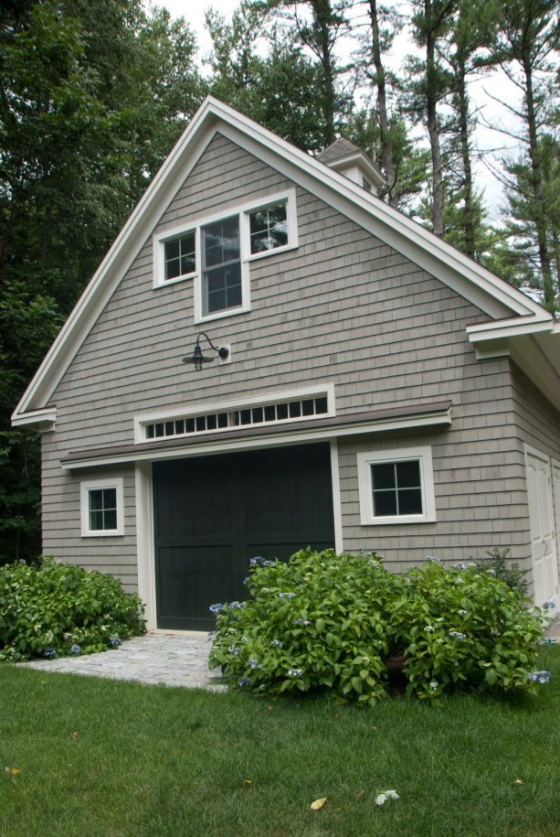 a black garage door looks bold and compatible with the grey farmhouse cottage shed