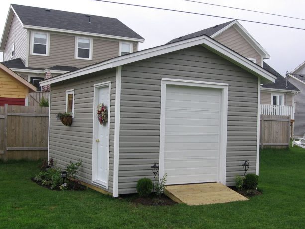 a deluxe shed look beautiful with the combination of grey walls and white sectional garage door