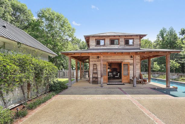 a farmhouse residence with brick and exposed aggregate concrete pool patio design