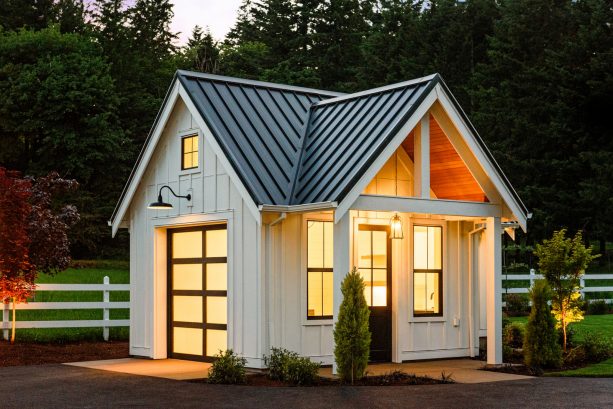 a farmhouse shed looks gorgeous with its white color and yellow interior lighting