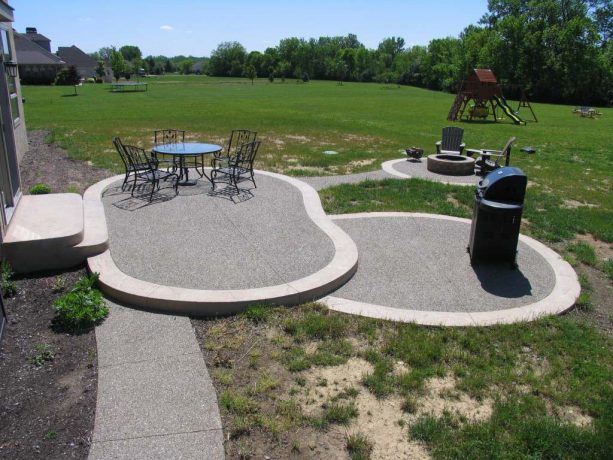 an exposed aggregate look in a traditional multi-level concrete patio and walkway