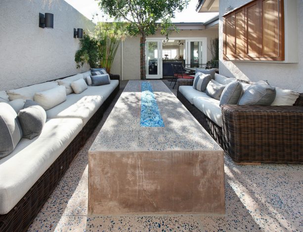 an outdoor living room in a patio with exposed aggregate concrete floor