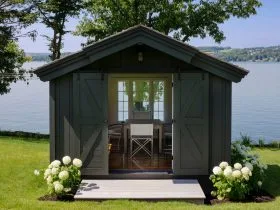 greyish brown writing and workshop studio shed with double sliding door garage door
