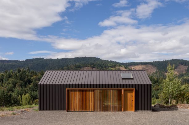 modern charcoal sheet metal tractor shed with very unique wooden sliding door