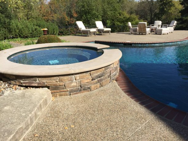 pool deck and patio with exposed aggregate concrete floor