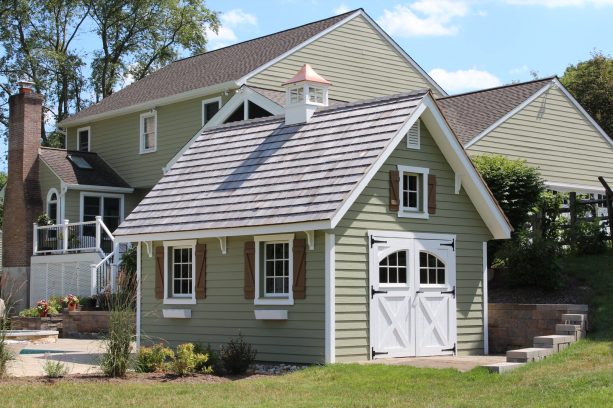 the coordinating taupe exterior between the colonial garden shed and the main house