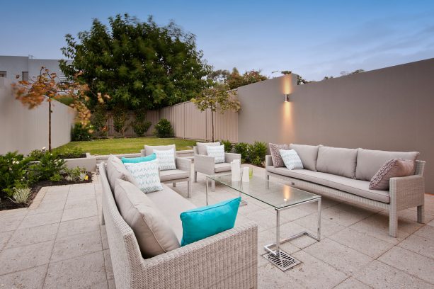 the neutral theme of a modern patio with exposed aggregate floor in a coordinating color