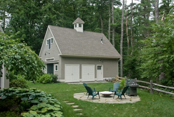 the side of the shed also has two white garage doors