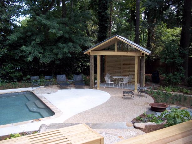 the swimming pool patio has the unique, patterned combination of concrete and exposed aggregate materials