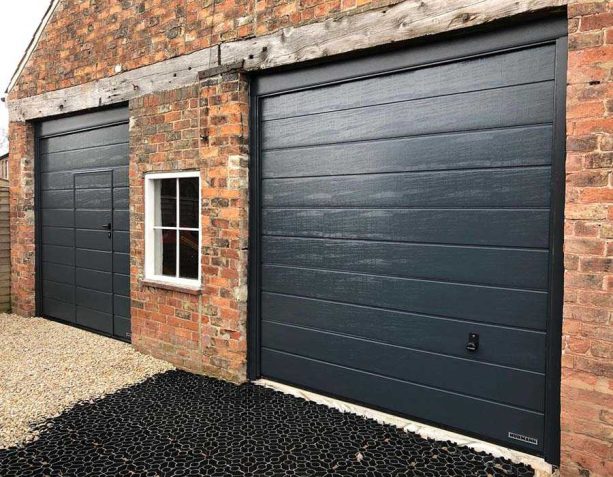 a brick garage with wicket in one of its bold, black doors