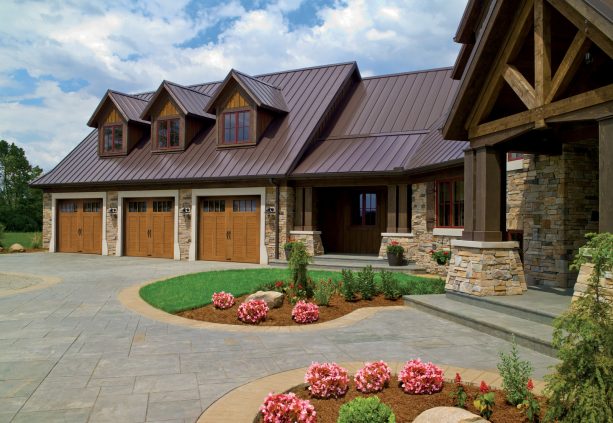 a coordinating color between the wood-looking garage doors and the siding of the dormer windows above them