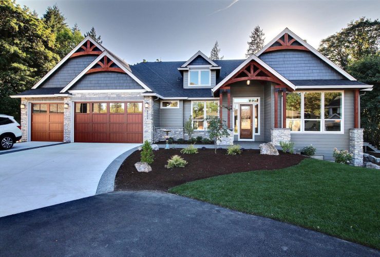 a craftsman exterior with aluminum garage doors that looks like real wood