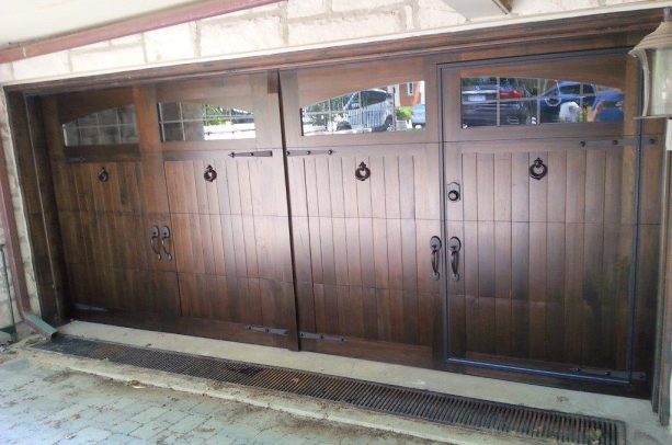 a custom wood face garage door with concealed man entry
