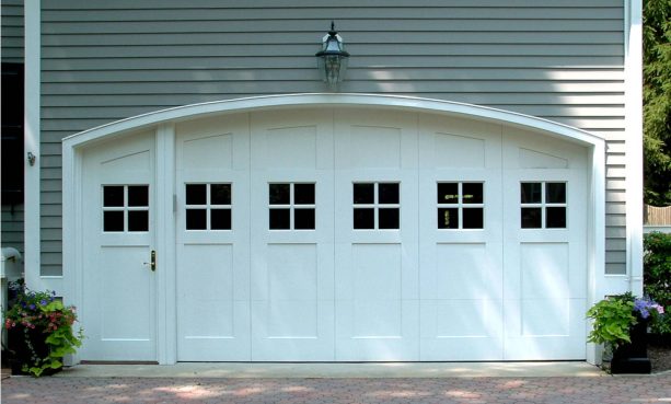 a fabulous white arched garage door with walk-through entry on the left side