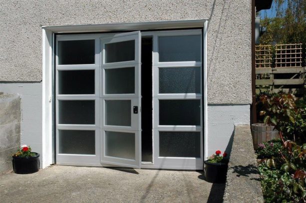 a glass garage door with man entry in the middle